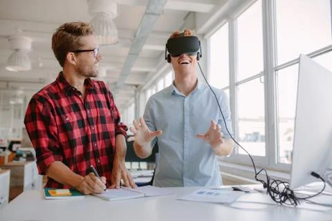 Young developers testing new virtual reality device Stock Photos