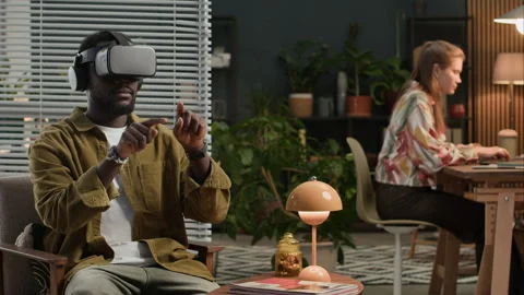 Young Developers Using Augmented Reality Glasses and Computers at IT Office Stock Footage 302893675