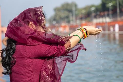 Young devotee praying for holy god after bathing in holy river water at mor.. 写真素材