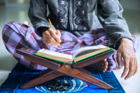 Young devout man reading Quran Stock Photos