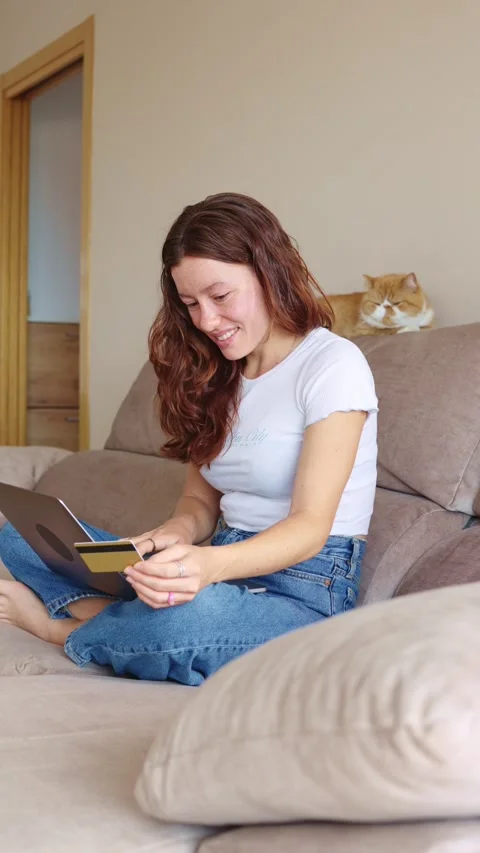 Young digital native finalizing her home-based online payment 動画素材 247546522