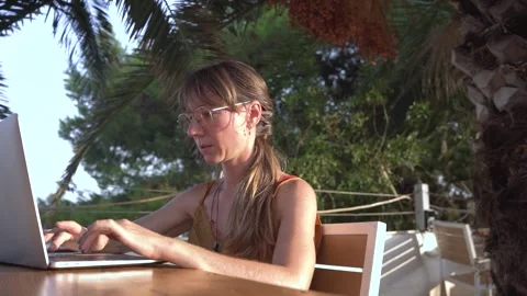 Young digital nomad woman doing remote work on laptop at outdoor terrace cafe Stock Footage 345046567