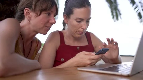 Young digital nomad women doing remote work on laptop at outdoor terrace cafe Vidéo 345046591
