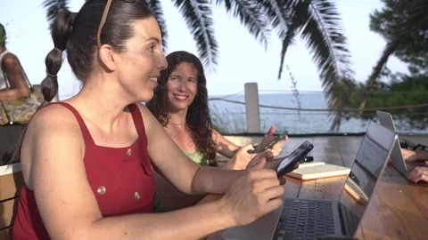 Young digital nomad women doing remote work on laptop at outdoor terrace cafe Stock Footage 345046596