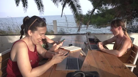 Young digital nomad women doing remote work on laptop at outdoor terrace cafe Stock Footage 345046600