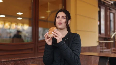 Young diner, Hamburger outing, dark-haired eater Stock Footage 248954895