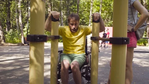 Young disable man doing exercises on the parallel bars Stock-Footage 93811867