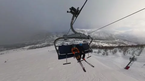 Young disabled boy taking ski-lift using sitski foir handicapped Stock Footage 241010057