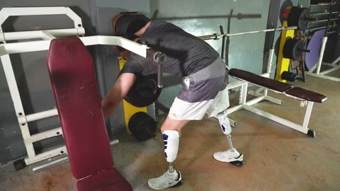 Young disabled man with dumbbells training in gym Stock Footage 248948117