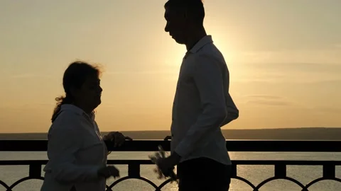 Young disabled man gives present for woman at back sunset Stock Footage 202161674
