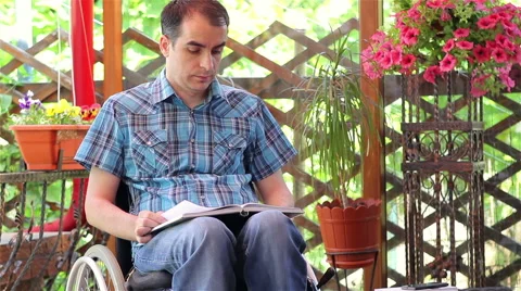 Young disabled man reading book 스톡 동영상 50647310