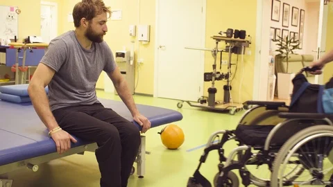 Young disabled man sitting down in a wheelchair Stockbeeldmateriaal 93830078