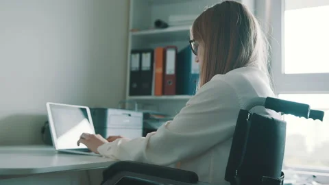 Young disabled student using the laptop in study room Stock Footage 139390587