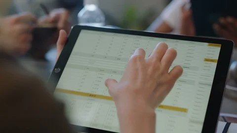 Young diverse business people meeting using tablet computer viewing financial Stock Footage