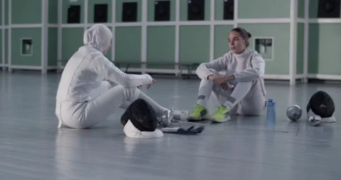 Young diverse fencers having conversation during break Stock Footage 224964098