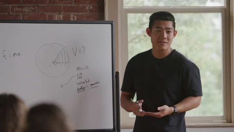 Young Diverse Math Teacher Explains Problem to Students Using White Board Stock Footage 208796287