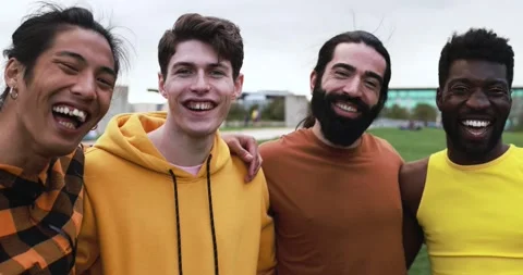 Young diverse men having fun laughing together at city park Stock Footage 192382723