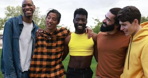 Young diverse men having fun laughing together at city park Stock Footage 192383975