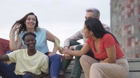 Young diverse people having fun using mobile phones outdoor in the city Stock Footage 162275657