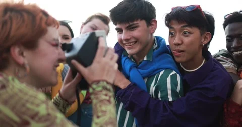 Young diverse people having fun with old vintage camera outdoor Stock Footage 185510645