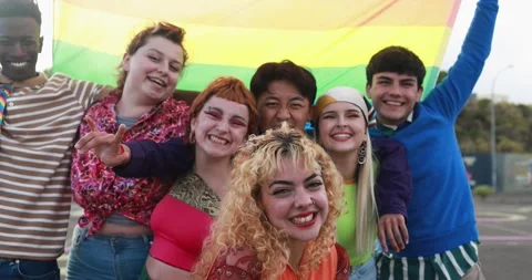 Young diverse people having fun holding LGBT rainbow flag outdoor Stock Footage 185515733