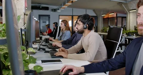 Young diverse people working at computers. Call center office. Men and women in Stock Footage 179951264
