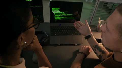 Young Diverse Programmers Discussing Work in front of Laptop at Desk Video stock 292632417