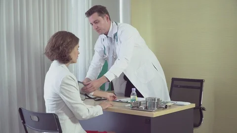 The young doctor is checking the pulse of the sick woman. Stock Footage 121132953