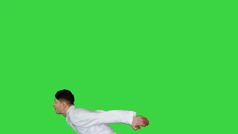 Young doctor does back flip Victory! on a Green Screen, Chroma Key. Stock-Footage 139935207