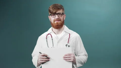 A young doctor in glasses posing in white lab coat with pen and medical report Stock Footage 170670943