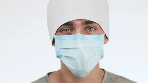 A young doctor looking at the camera while standing in the hospital. It stands Stock-Footage 58627553