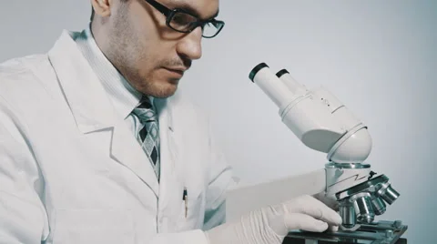 Young doctor  looking through the microscope 스톡 동영상 54912389
