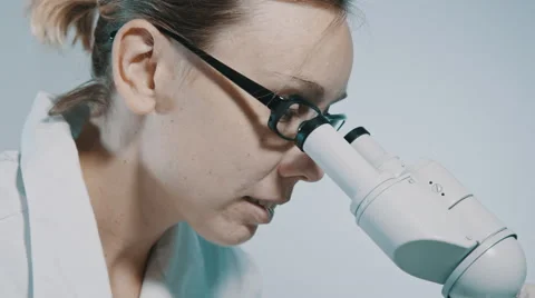 Young doctor  looking through the microscope Stockbeeldmateriaal 54913237