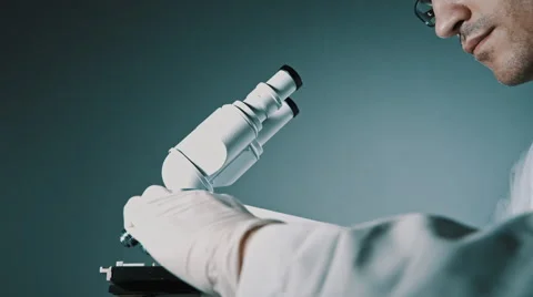 Young doctor  looking through the microscope 動画素材 56356182