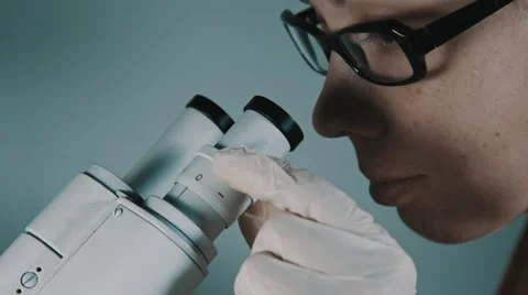 Young doctor  looking through the microscope Stock Footage 56362338