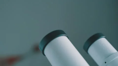 Young doctor  looking through the microscope Stock Footage 59821456