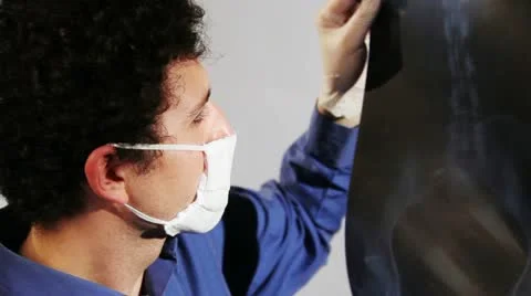 Young doctor looking x-ray image Stock Footage 11009064