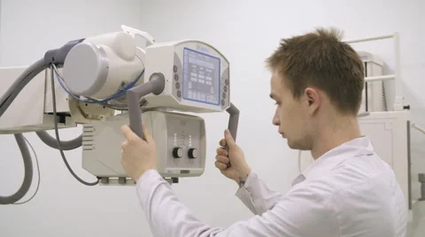 Young doctor moving xray machine Stock Footage 62347876
