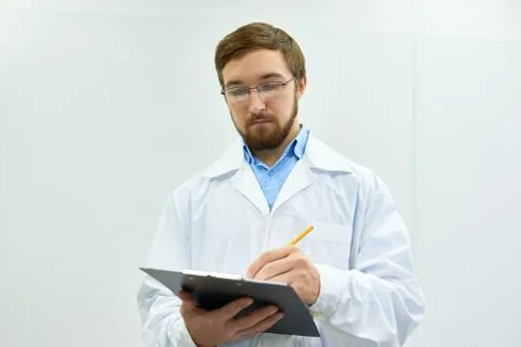 Young Doctor Posing by White Wall Stock Photos
