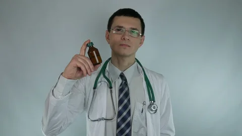 Young doctor recommends potion Stock Footage 87827599