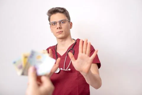 Young doctor refusing bribe in exchange for his services Stock Photos