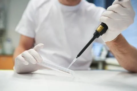 Young doctor testing sample of reactive substance Stock Photos