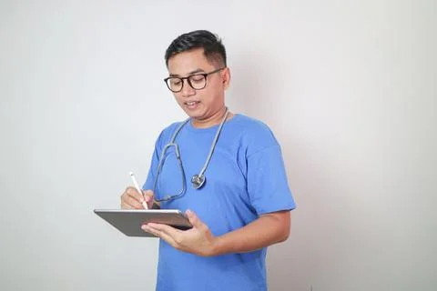 Young Doctor using digital tablet Stock Photos