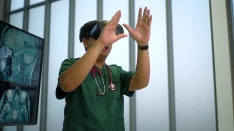 Young doctor using virtual reality headset for training on medical purpose. Stock Footage 276490518