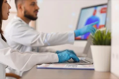 Young doctors analyzing scientific data at desk in laboratory, closeup Stock Photos