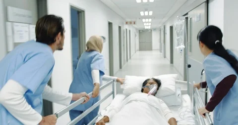 Young doctors pulling hospital bed rushing 4k Stock-Footage 112036877