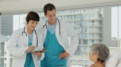 Young Doctors Talking with an Elderly Patient Stock Footage 892627