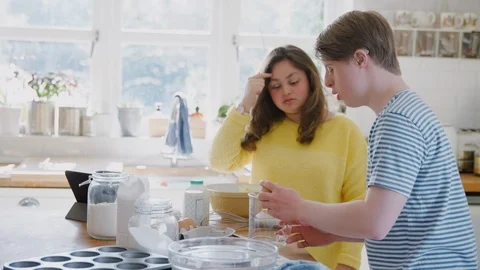 Young Downs Syndrome Couple Cracking Eggs For Cake Recipe They Are Baking In Stock Footage 114303348