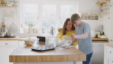 Young Downs Syndrome Couple Having Fun Baking In Kitchen At Home Stock Footage 114302998