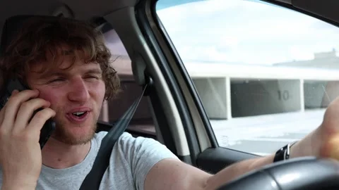 Young driver talks on a handheld phone while  Stock Footage 343720412
